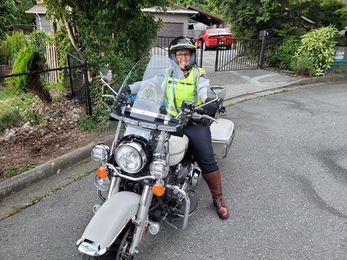 Cst. Tania Saunders sitting on her RCMP Motorcycle