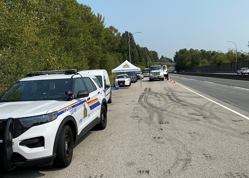 Roadside CVSE check stop with a marked RCMP vehicle in the front
