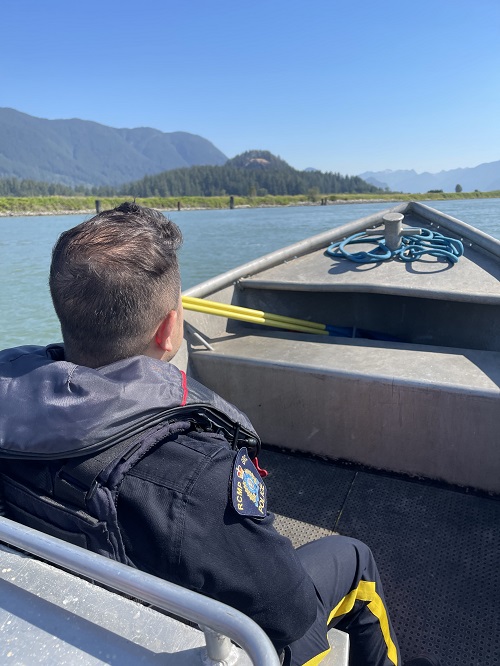 L’agent du Détachement de la GRC de Coquitlam fait face au devant du bateau de police qui navigue sur la rivière Pitt